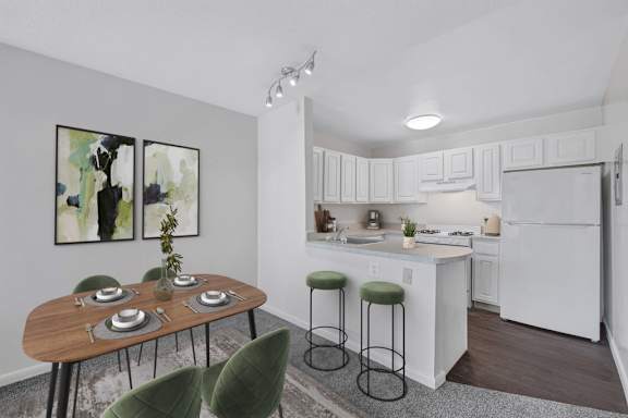 A kitchen with a black countertop and white cabinets.
