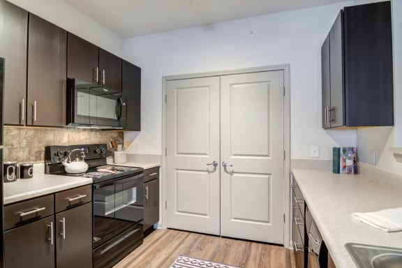 Kitchen with dark wood cabinets and hardwood floor