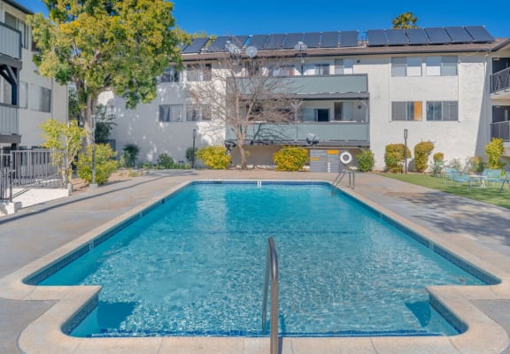 a swimming pool in front of an apartment building at The Hills Apartments at Thousand Oaks, Thousand Oaks, CA 91360