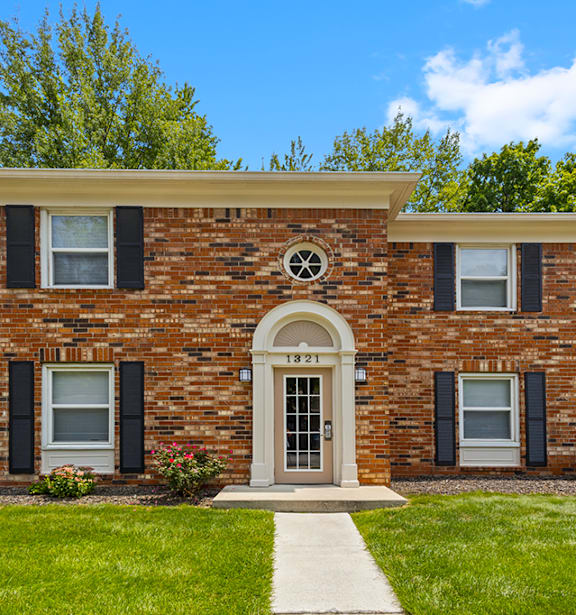 A brick building with a white door and windows.