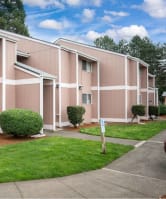lawn outside apartment building building with a brown and white exterior and a green lawn in front.  at Fort Vancouver Terrace, Vancouver, WA, 98661