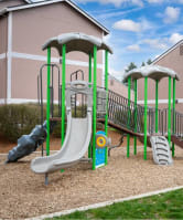 A playground with a green slide and a yellow circle on the ground. at Fort Vancouver Terrace, Vancouver, WA, 98661