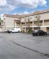 an empty parking lot in front of an apartment building at Quail Run Apartments, Washington 98684