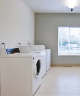 an empty laundry room with washes and washing machines at Quail Run Apartments, WA