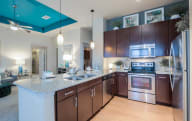 a modern kitchen with stainless steel appliances and granite counter tops at Imperial Lofts, Texas, 77498