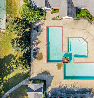 A swimming pool surrounded by a concrete patio and a grassy area at The Trails at Mt. Moriah, Tennessee