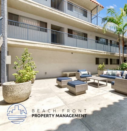 A laundry room with washers and dryers and a sign that says Beach Ront Property Management.
