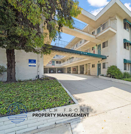 A multi-story building with a Peach Front Property Management sign in front.