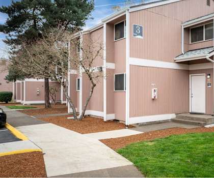A building with a white door and a window with a blue sign on it. at Fort Vancouver Terrace, Vancouver, WA, 98661