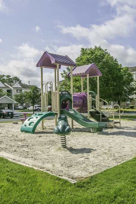 A playground with a slide and climbing frame.