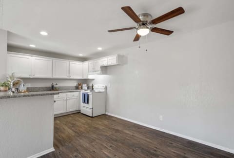 a kitchen and a living room with a ceiling fan at Aspire Rialto, Rialto