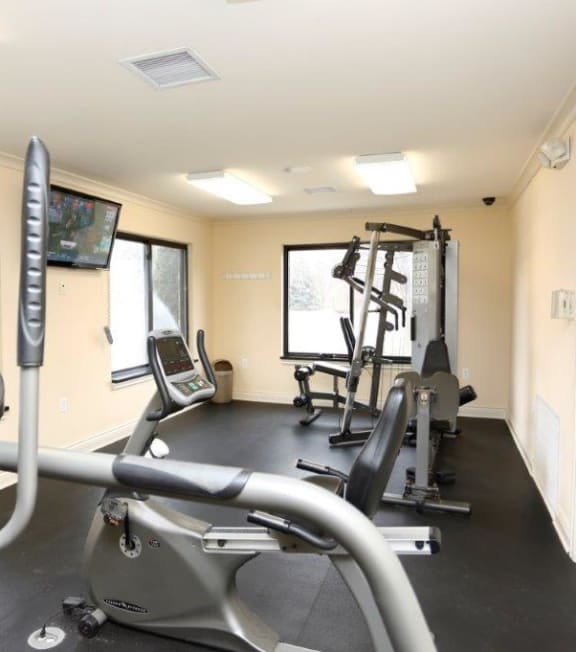 a gym with weights and cardio equipment in a building