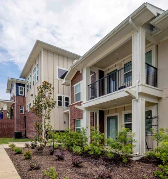 Apartment building with a car parked in front.