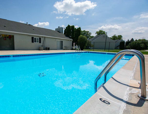 our resort style swimming pool is next to our building with lounge chairs