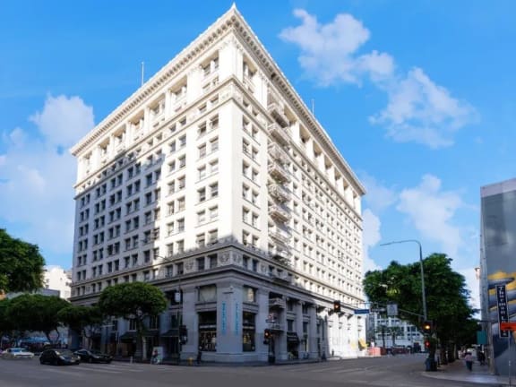 a large white building on the corner of a street