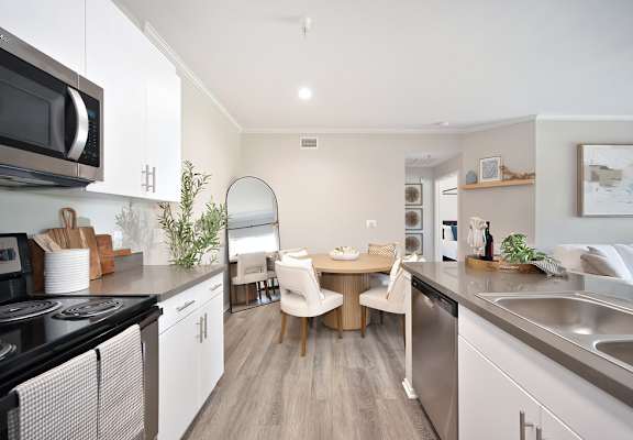 A modern kitchen with a dining table and chairs.