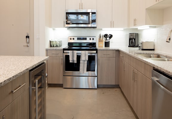 A modern kitchen with a stainless steel oven and microwave above the stove.