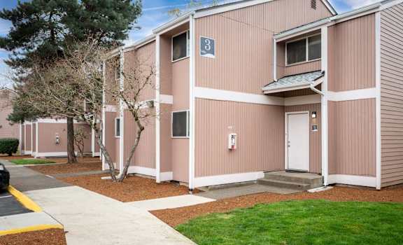A building with a white door and a window with a blue sign on it. at Fort Vancouver Terrace, Vancouver, WA, 98661