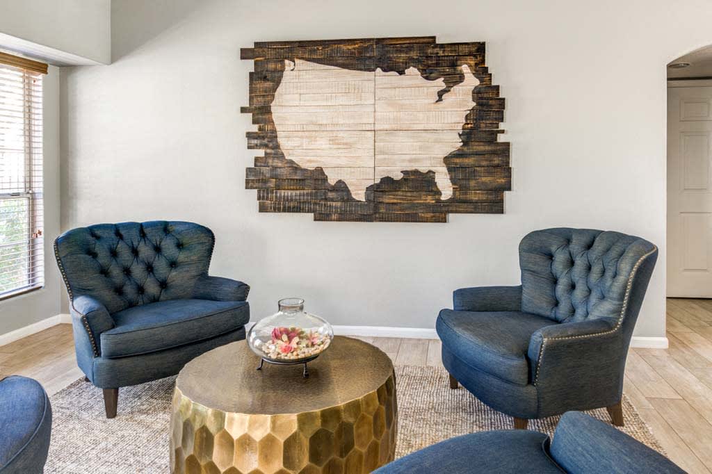 The Palms clubhouse lounge with navy chairs and coffee table - Phoenix, AZ