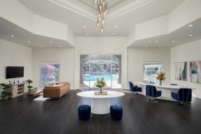 The Highland apartments leasing office with dark faux wood floors, white walls and views of the pool