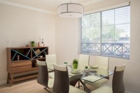 model dining room with table for 6 and large sideboard table, large windows and lighting