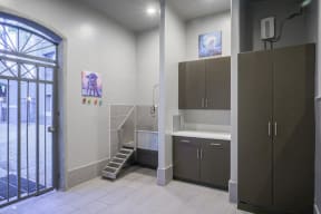 Pet Wash Station with white floors, brown cabinets and door to outside