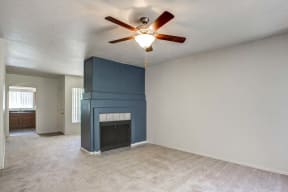 The Palms Apartments Living Room with wall to wall carpet, and dark blue fireplace