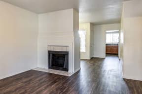 The Palms Apartments Living Room with hardwood-style flooring, fireplace, and light grey walls