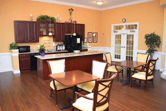 a kitchen and dining room with a table and chairs