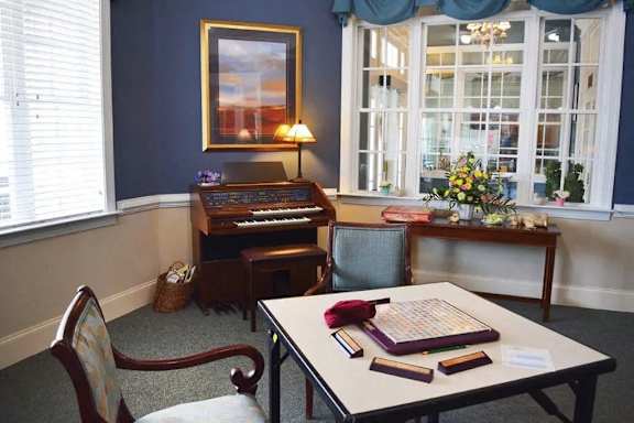 a small room with a table and a piano