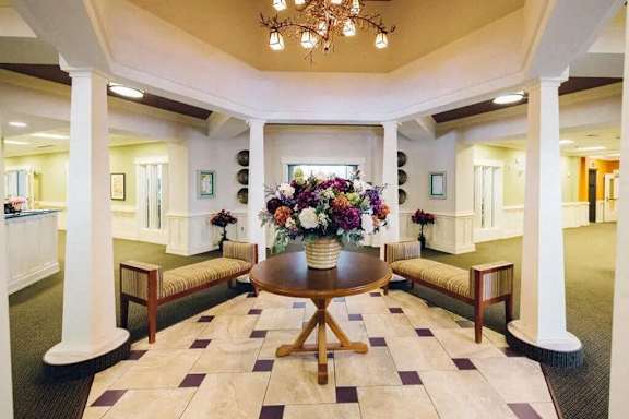 a lobby with a vase of flowers on a table