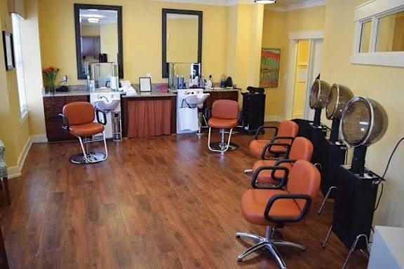 a salon room with chairs and a barbershop