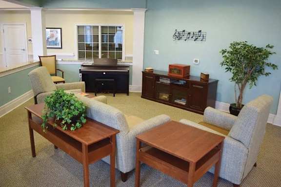 a living room with a couch and chairs and a table