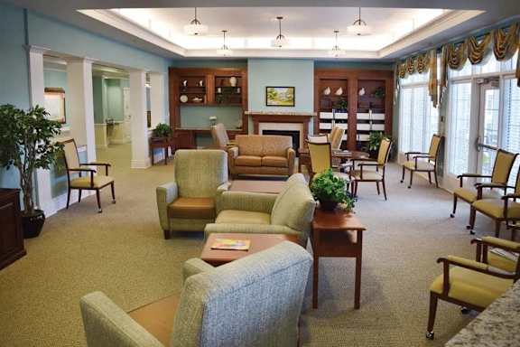 a living room filled with furniture and a table and chairs
