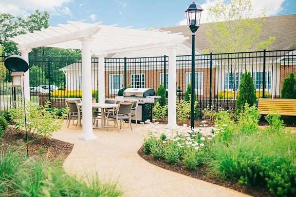 a patio with a table and chairs under a white canopy