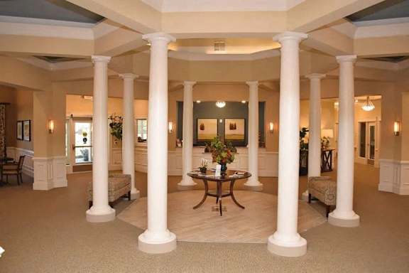 a large lobby with columns and a table