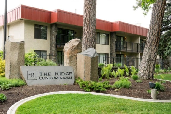 the ridge condominiums sign in front of a building
