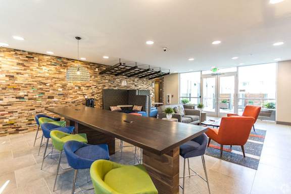 A modern living room with a flat screen TV mounted on the wall.