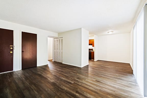 A room with wooden floors and white walls.