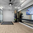 the gym is equipped with treadmills and weights at the apartments