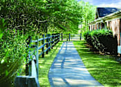 Thumbnail 1 of 4 - a sidewalk in front of a house with a wooden fence