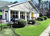 Thumbnail 2 of 4 - a porch with a table and chairs in front of a house