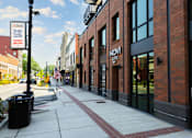 Thumbnail 1 of 8 - A brick building with a sign that says "NOMA Offers" on it.