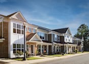 Thumbnail 2 of 5 - a row of town homes on a street