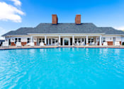 Thumbnail 1 of 18 - Daytime image of pool and clubhouse