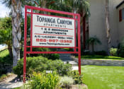 Thumbnail 38 of 41 - Apartments for Rent in West Hills - Topanga Canyon - Exterior View of Monument Sign with Lush Landscaping and View of Apartment Building