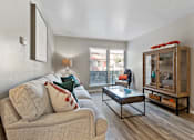 Thumbnail 14 of 27 - Living room with modern furnishings and glass display cabinet at The Colony Apartments, Texas, 78148