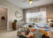 Thumbnail 11 of 21 - Big bedroom, Dresser, nightstands, carpet and walk in closet at Ascent at Mallard Creek Charlotte, NC