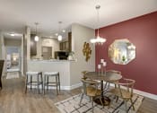 Thumbnail 5 of 21 - Dining room and kitchen. Stools at kitchen. Small dining room table with four chairs at Ascent at Mallard Creek Charlotte, NC