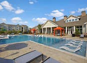 Thumbnail 1 of 21 - Swimming Pool. Big spacious pool with chairs in shallow end, loungers, cabanas at Ascent at Mallard Creek Charlotte, NC